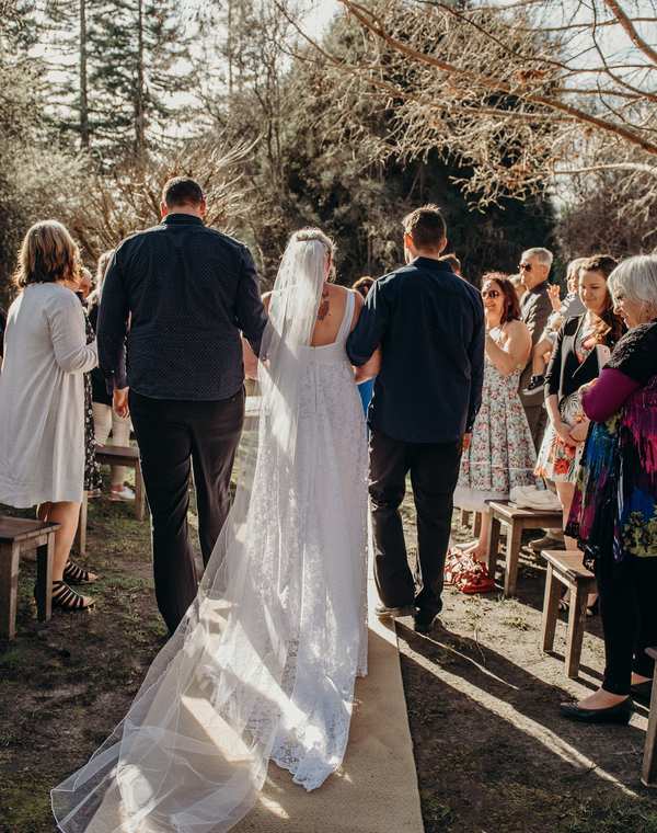 Outdoor wedding ceremony aisle in the gardens at The Playhouse wedding venue, Māpua Nelson