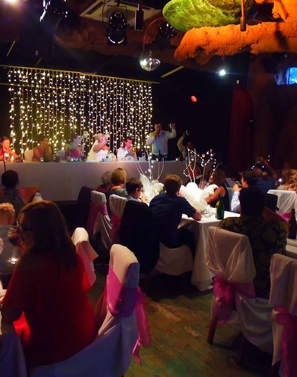 Wedding guests celebrating at a reception in The Playhouse theatre room, Nelson NZ